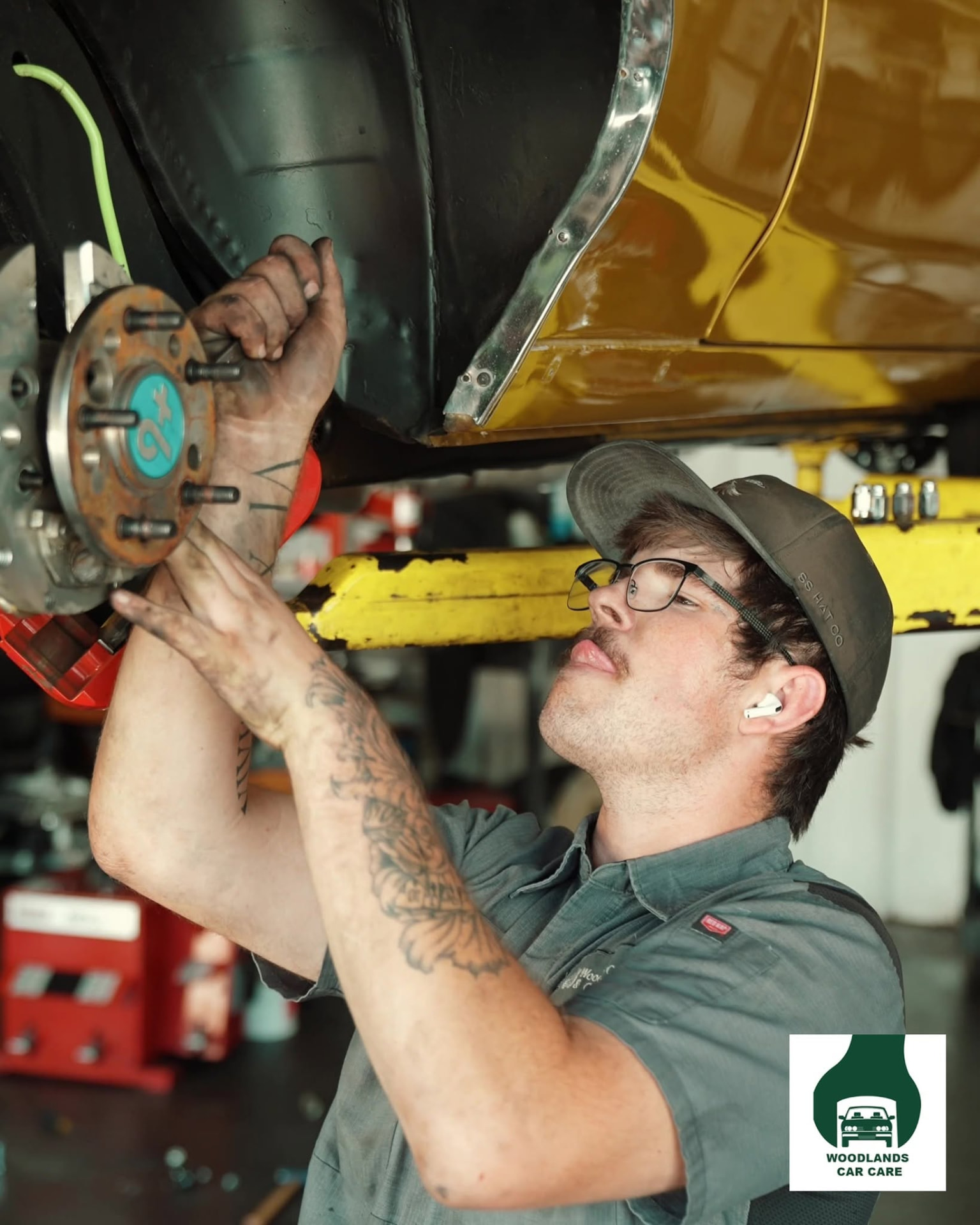 Woodlands Car Care technician working in the service bay on Budde Road